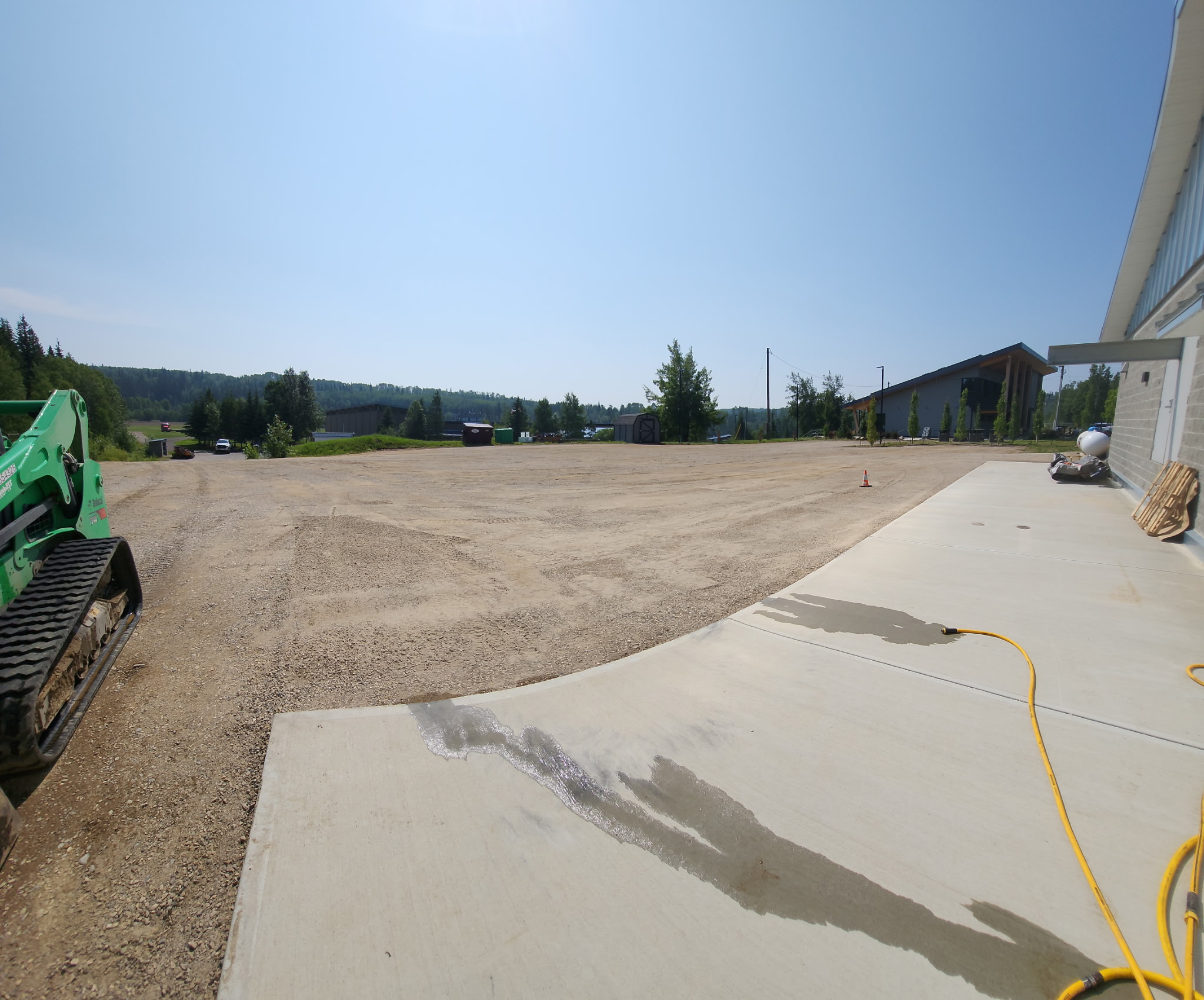 DLK skid steer on a freshly graded gravel base