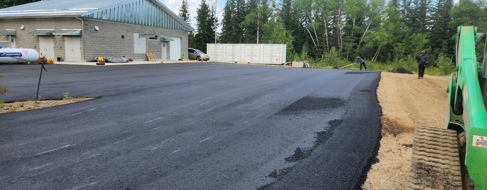 DLK crew laying fresh asphalt on a commercial lot